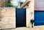Black aluminium pedestrian gate with solid infill,vertical slats and a flat top in-situ. image