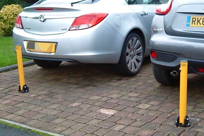 A couple of erected Folding Parking Post with Integral Lock. Locked in position image