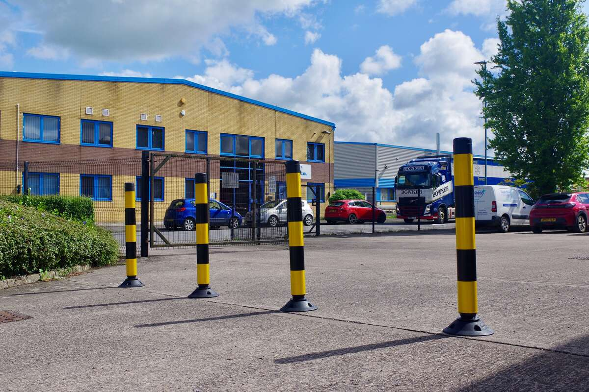 Traffic Cone Guide; Flexible Posts in Hi-Viz Yellow and Black in a commercial car park.Â